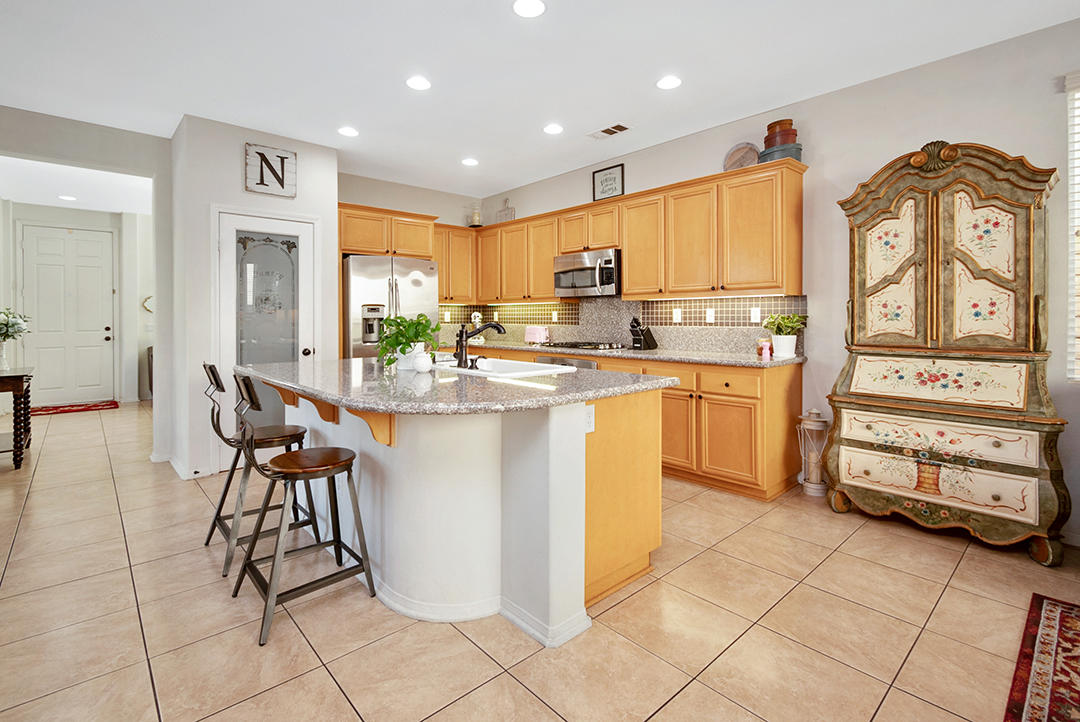 28938 Mirada Circulo Valencia, CA 91354 - Photo 14 of 56 a kitchen with stainless steel appliances granite countertop a stove top oven a sink a dining table and chairs