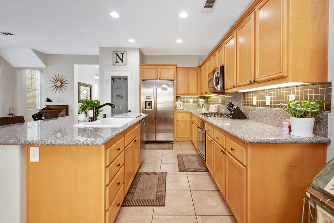 28938 Mirada Circulo Valencia, CA 91354 - Photo 15 of 56 a kitchen with stainless steel appliances granite countertop a sink and cabinets