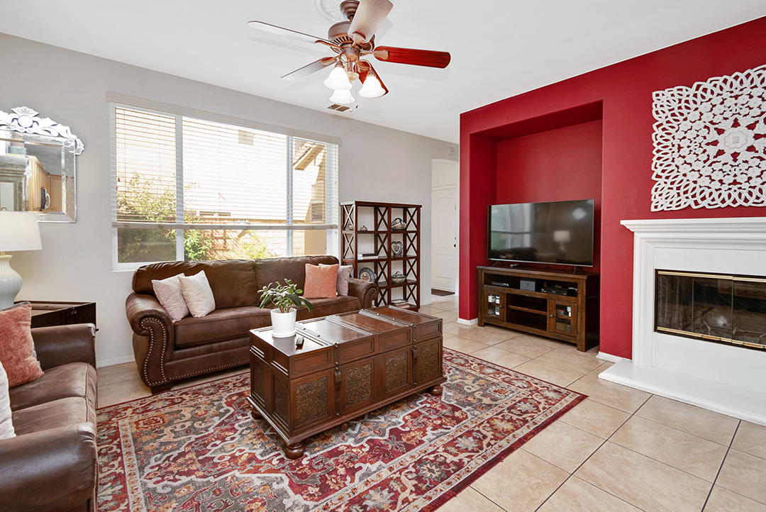 28938 Mirada Circulo Valencia, CA 91354 - Photo 17 of 56 a living room with furniture a flat screen tv and a fireplace