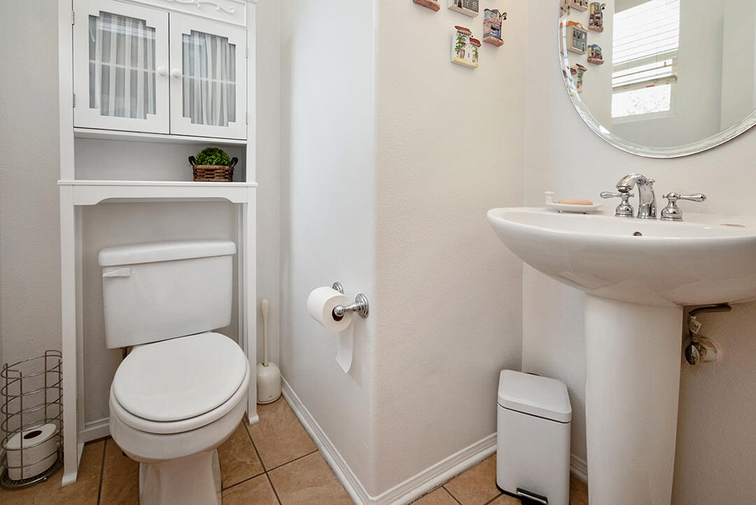 28938 Mirada Circulo Valencia, CA 91354 - Photo 20 of 56 a bathroom with a toilet a sink and a mirror