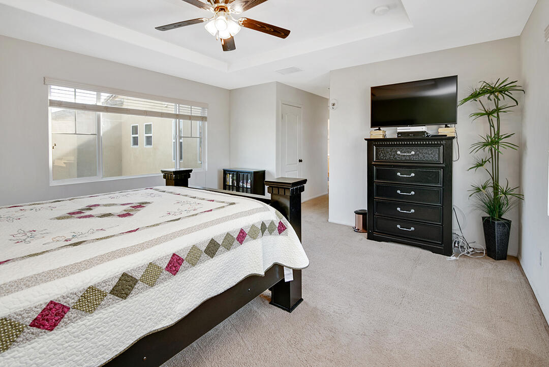 28938 Mirada Circulo Valencia, CA 91354 - Photo 23 of 56 a spacious bedroom with a bed a flat screen tv and a window