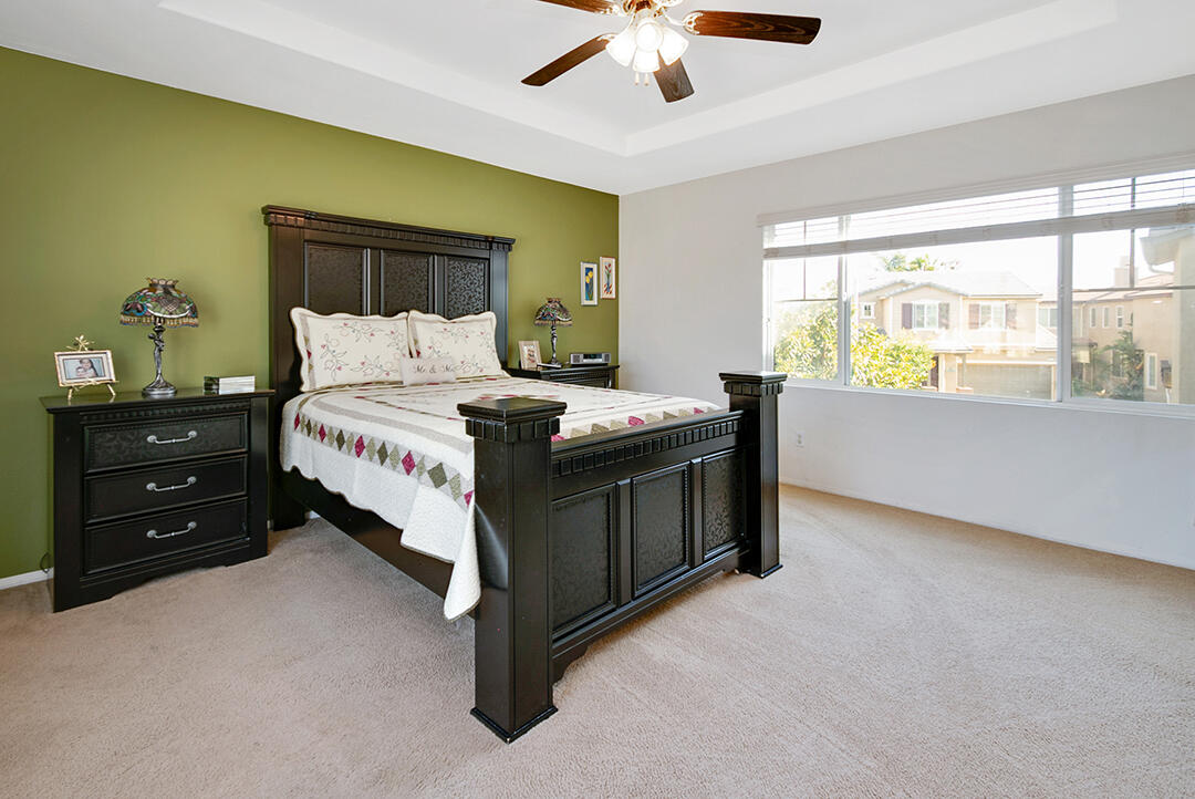 28938 Mirada Circulo Valencia, CA 91354 - Photo 24 of 56 a spacious bedroom with a bed and a chandelier