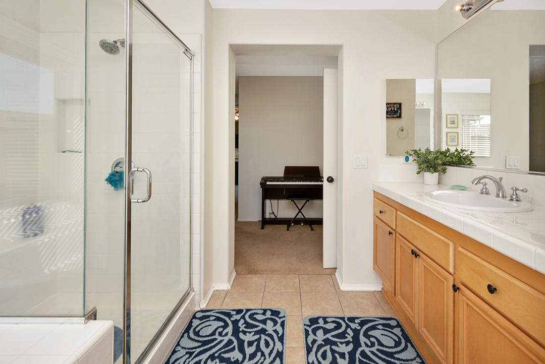 28938 Mirada Circulo Valencia, CA 91354 - Photo 28 of 56 a bathroom with a sink a toilet and shower