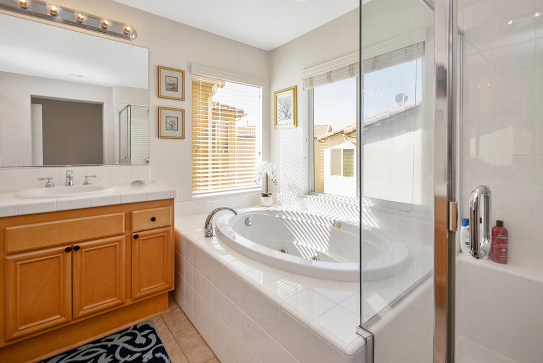 28938 Mirada Circulo Valencia, CA 91354 - Photo 29 of 56 a bath room with a sink and a large mirror