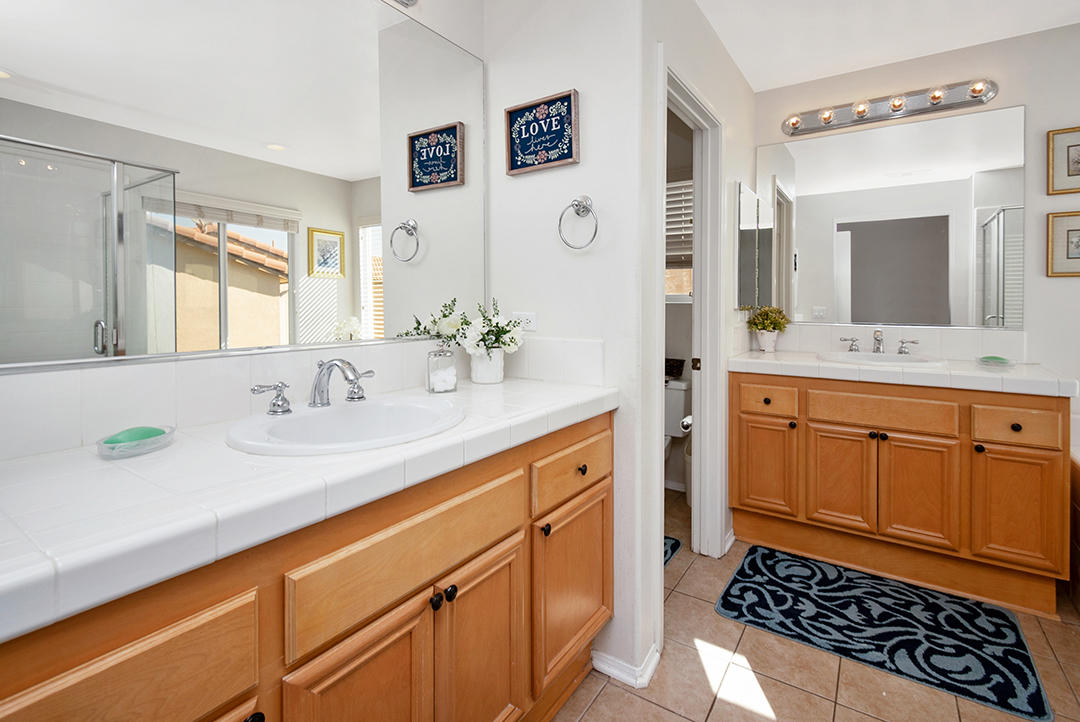 28938 Mirada Circulo Valencia, CA 91354 - Photo 30 of 56 a bathroom with a sink double vanity and a mirror
