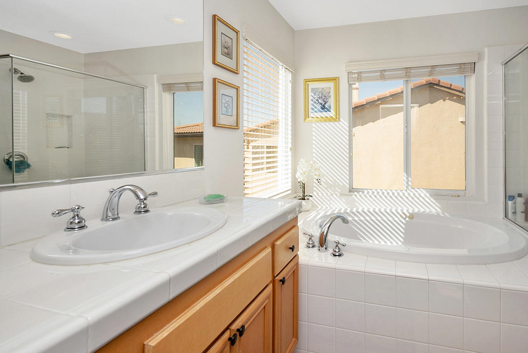 28938 Mirada Circulo Valencia, CA 91354 - Photo 31 of 56 a en suite bathroom with a granite countertop tub sink and mirror