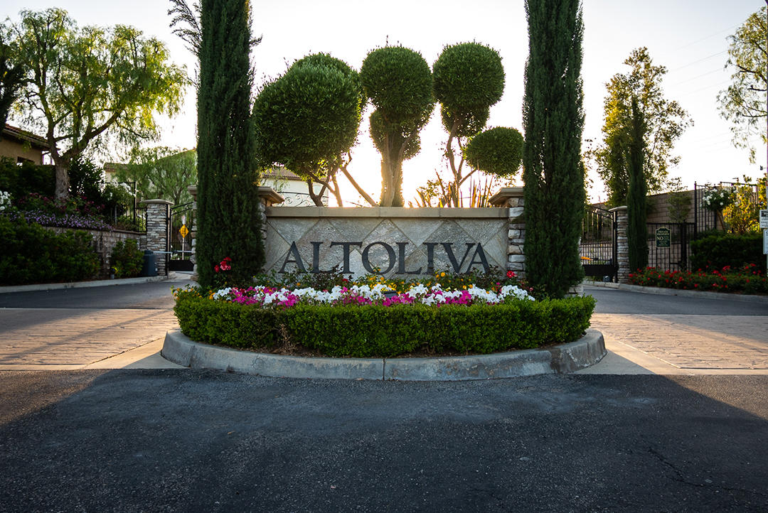 28938 Mirada Circulo Valencia, CA 91354 - Photo 45 of 56 a sign that is sitting in front of flowers
