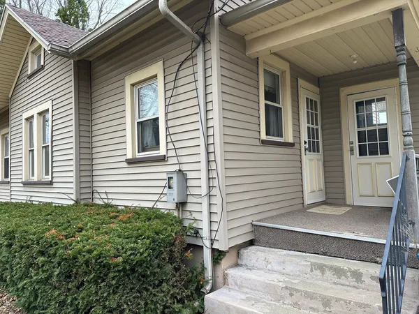 a view of a house with potted plants