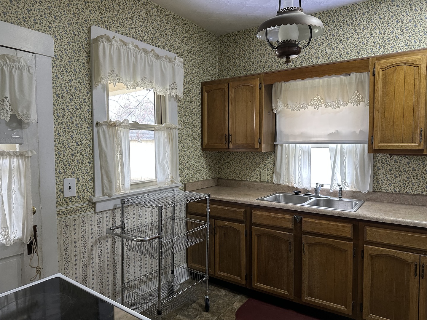 303 South Pleasant Street Princeton, IL 61356 - Photo 6 of 20 a kitchen with a sink a window and chandelier