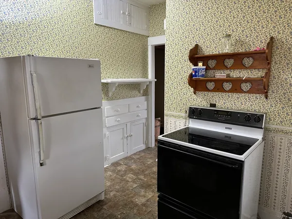 a kitchen with appliances and cabinets