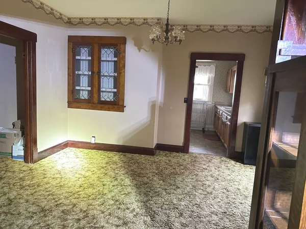 a view of an empty room and a bathroom