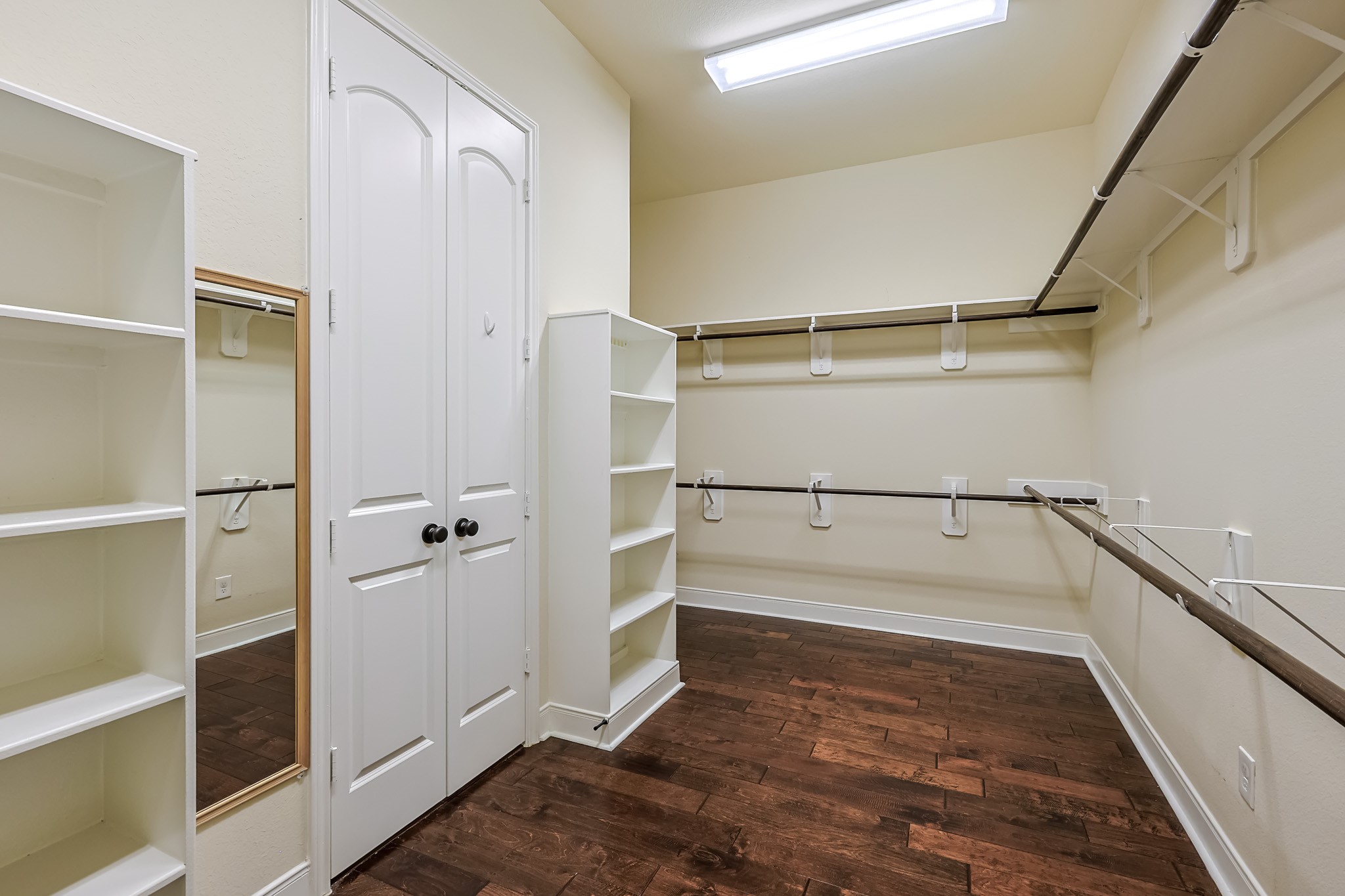 515 Mill Creek Road Pinehurst, TX 77362 - Photo 30 of 48 Spacious walk-in closet with hardwood floors and built in shelves, perfect for organized storage.