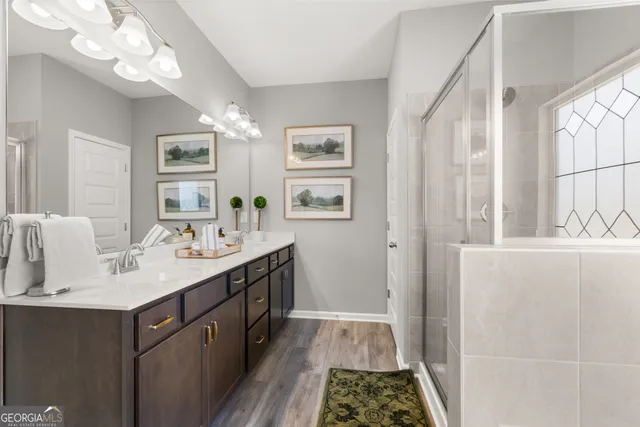 a bathroom with a double vanity sink and a mirror