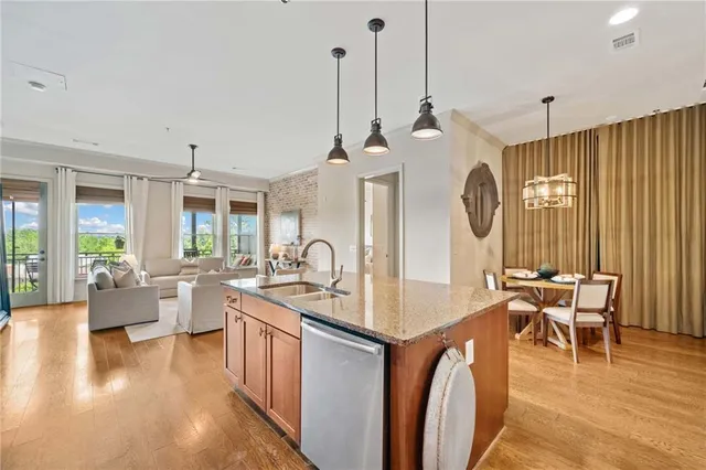 a living room with couches a flat tv screen and a dining table with garden view