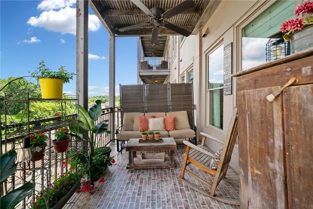 a view of balcony with couch and potted plants