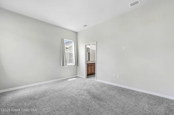 a bathroom with a granite countertop sink a mirror and a shower
