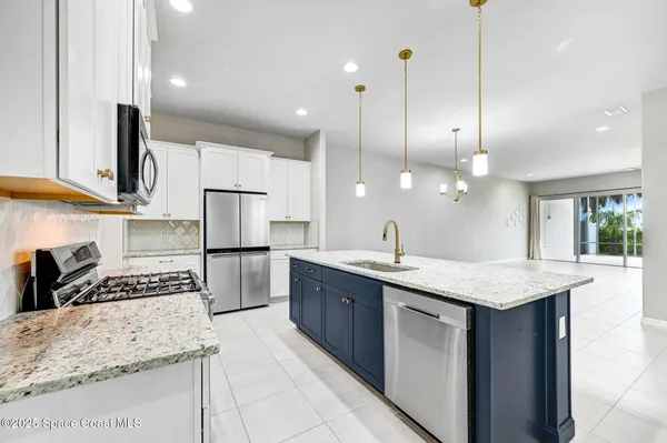 a kitchen with a stove a sink and a refrigerator