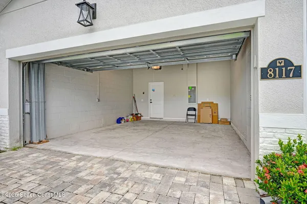 an aerial view of a swimming pool with outdoor seating