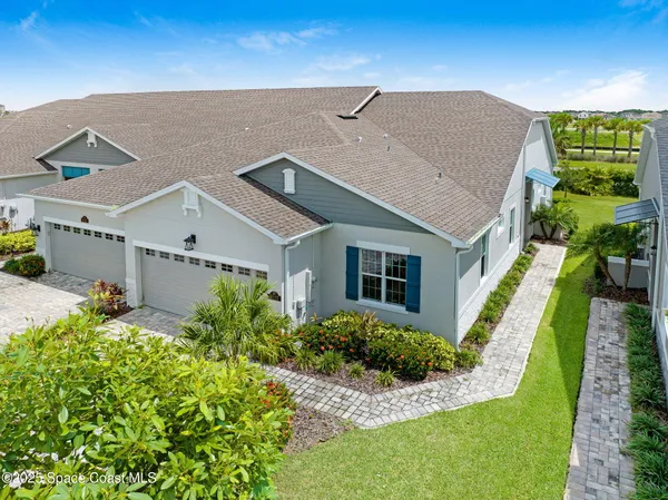 an aerial view of a house with swimming pool outdoor seating and yard