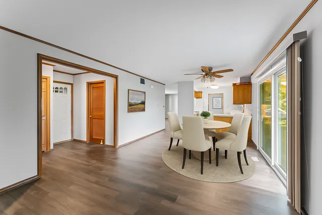 a dining room with furniture and wooden floor