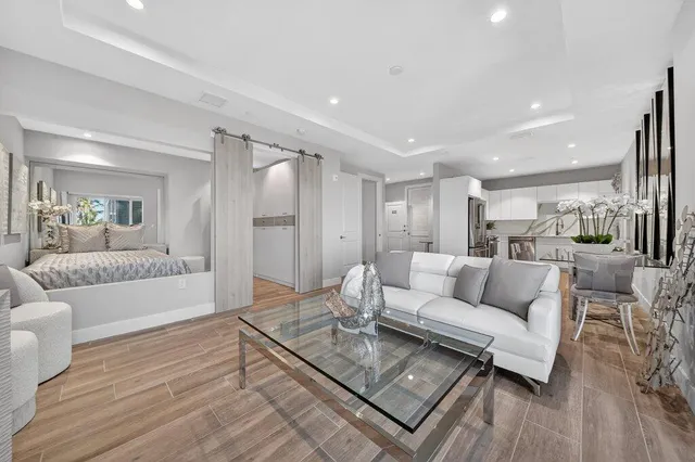 a living room with furniture and a wooden floor