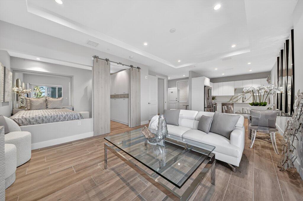 a living room with furniture and a wooden floor