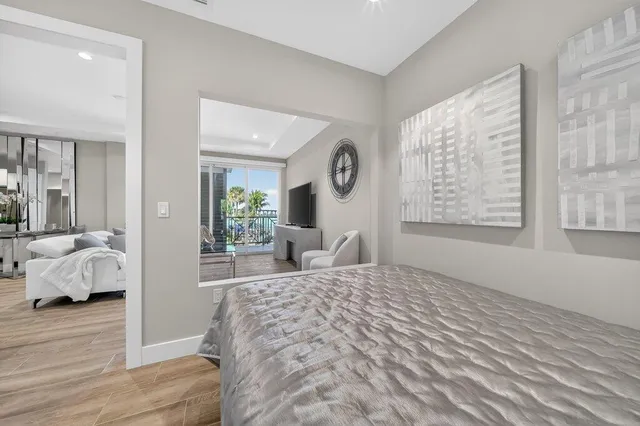 a bedroom with a large bed and a window