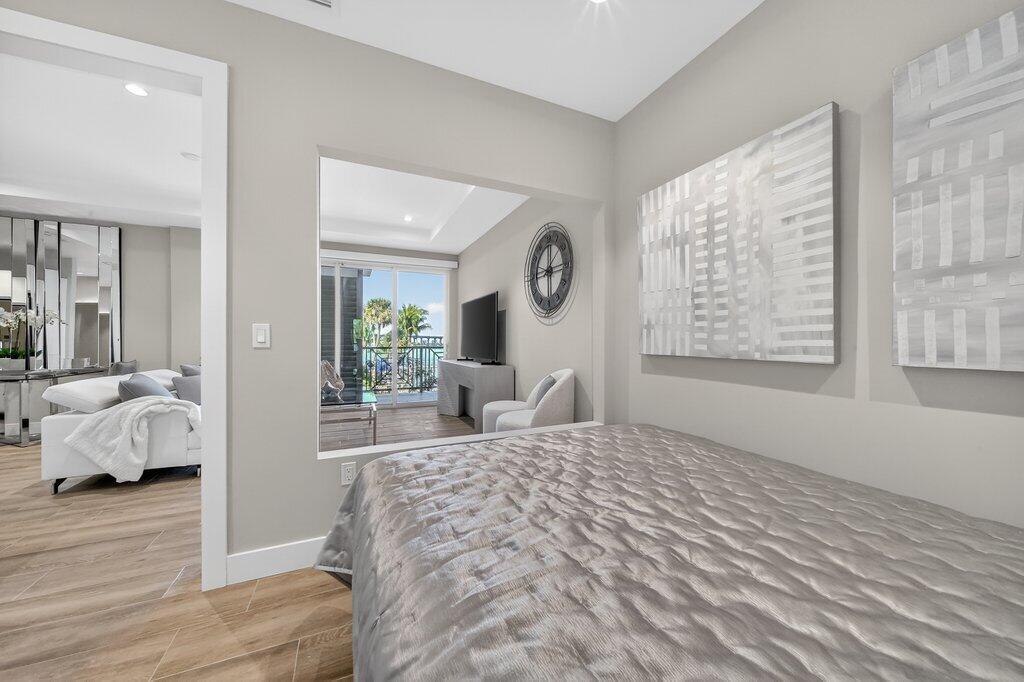 41 Southwest Seminole Street, Unit 304 Stuart, FL 34994 - Photo 12 of 29 a bedroom with a large bed and a window