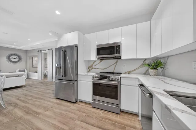 a kitchen with a refrigerator stove and microwave
