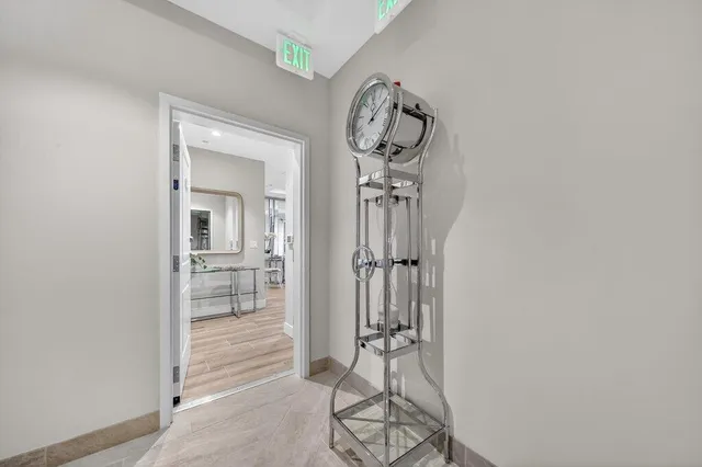 a view of a hallway with a glass door and a window