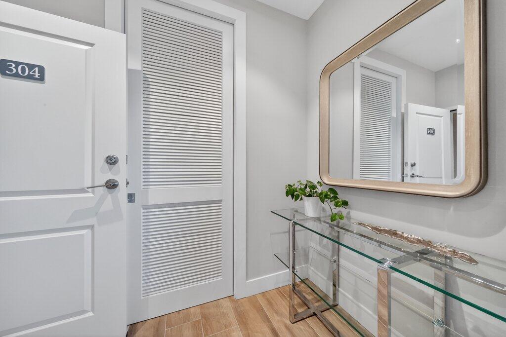 41 Southwest Seminole Street, Unit 304 Stuart, FL 34994 - Photo 8 of 29 a view of hallway with wooden floor