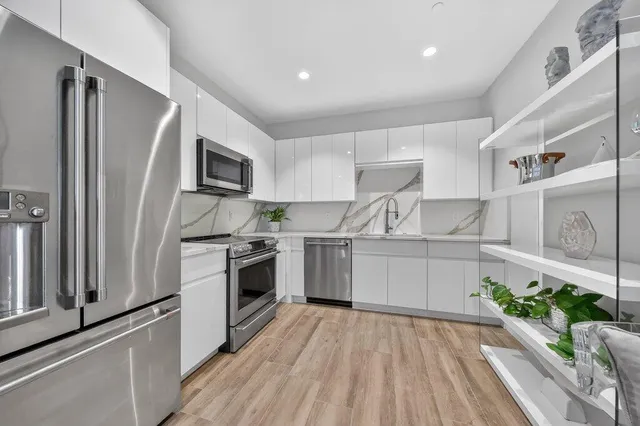 a kitchen with a sink stainless steel appliances and cabinets