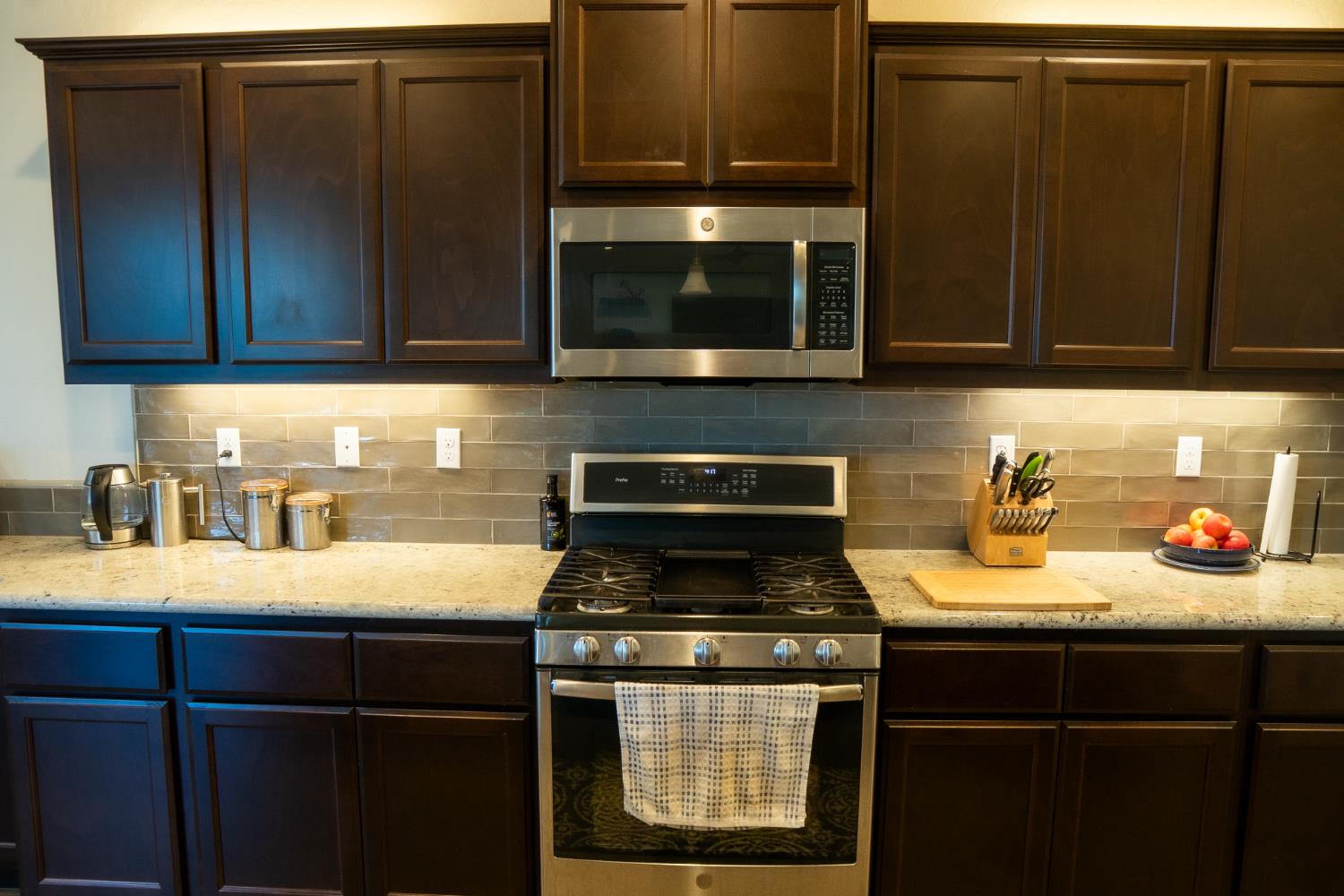 470 Daphne Lane Lemoore, CA 93245 - Photo 13 of 86 a kitchen with granite countertop stainless steel appliances a stove a microwave and sink