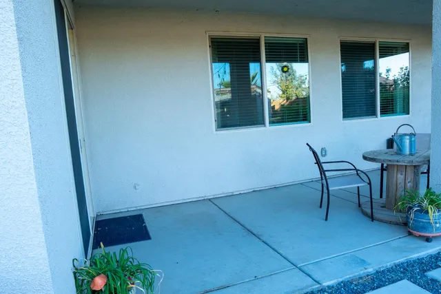 a living room with furniture a flat screen tv and a window