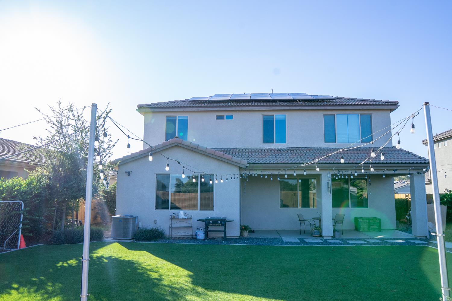 470 Daphne Lane Lemoore, CA 93245 - Photo 16 of 86 a front view of a house with a yard table and chairs
