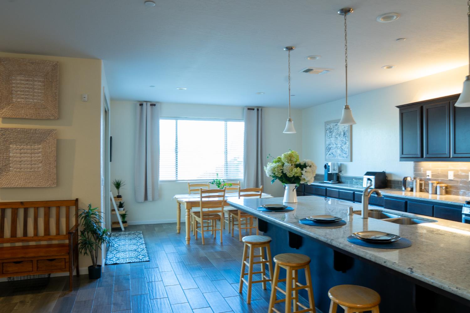 470 Daphne Lane Lemoore, CA 93245 - Photo 21 of 86 a kitchen with stainless steel appliances wooden floor a table and chairs in it