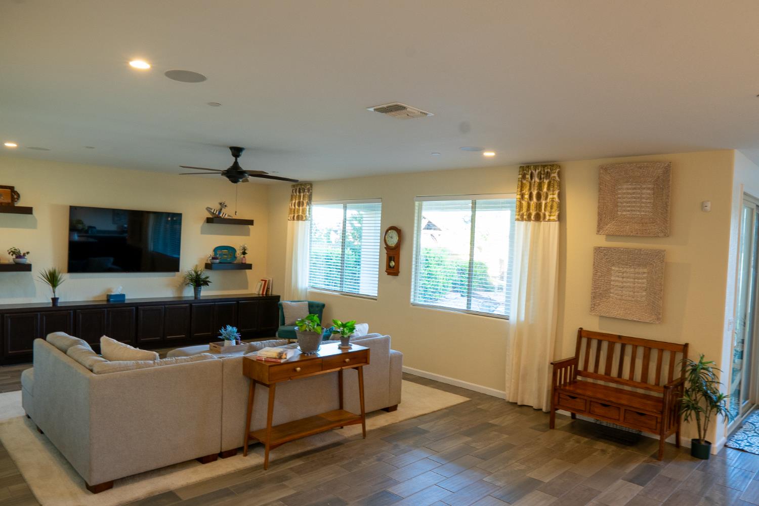 470 Daphne Lane Lemoore, CA 93245 - Photo 23 of 86 a living room with furniture a flat screen tv and a window