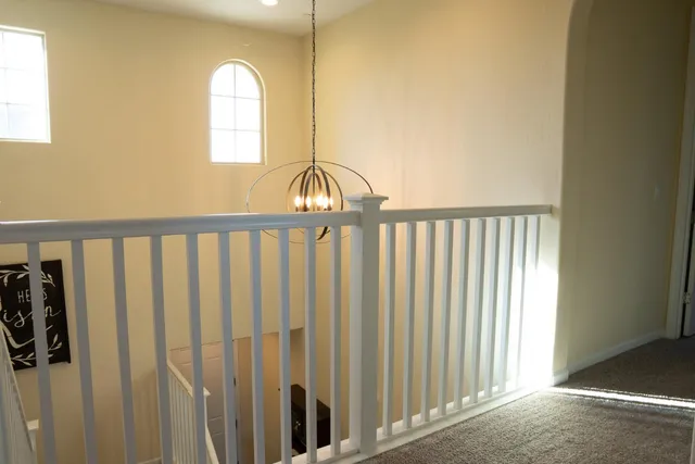 a bedroom with a bed a lamp and a window