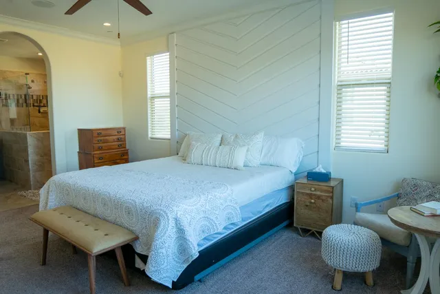 a bedroom with a bed and a chandelier