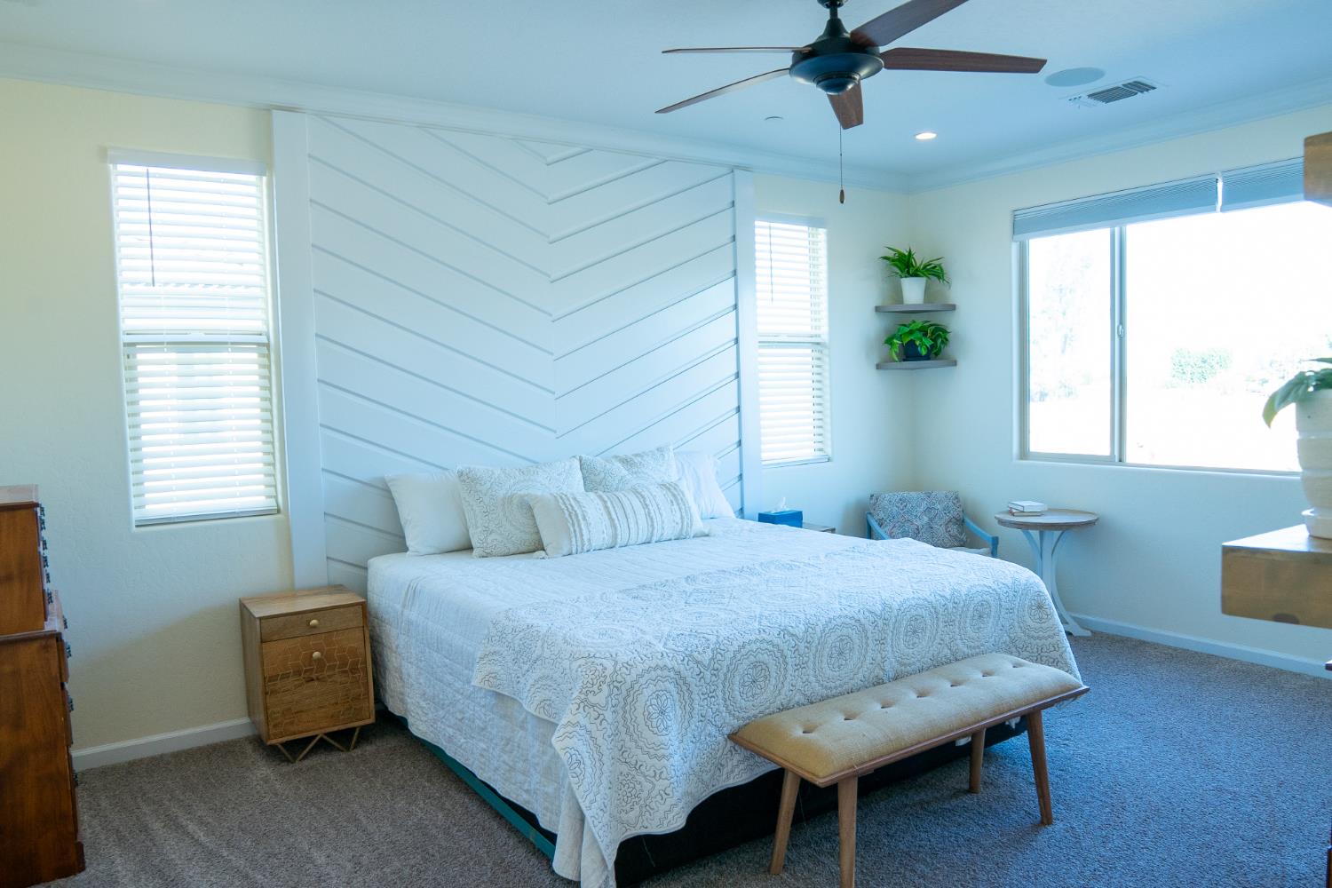 470 Daphne Lane Lemoore, CA 93245 - Photo 52 of 86 a bedroom with a bed a chandelier and a window