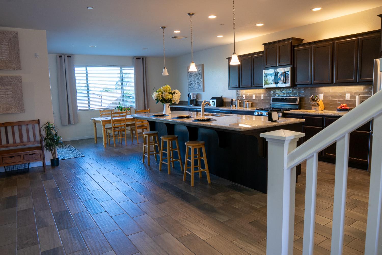 470 Daphne Lane Lemoore, CA 93245 - Photo 66 of 86 a kitchen with stainless steel appliances granite countertop a sink a stove and a wooden floors