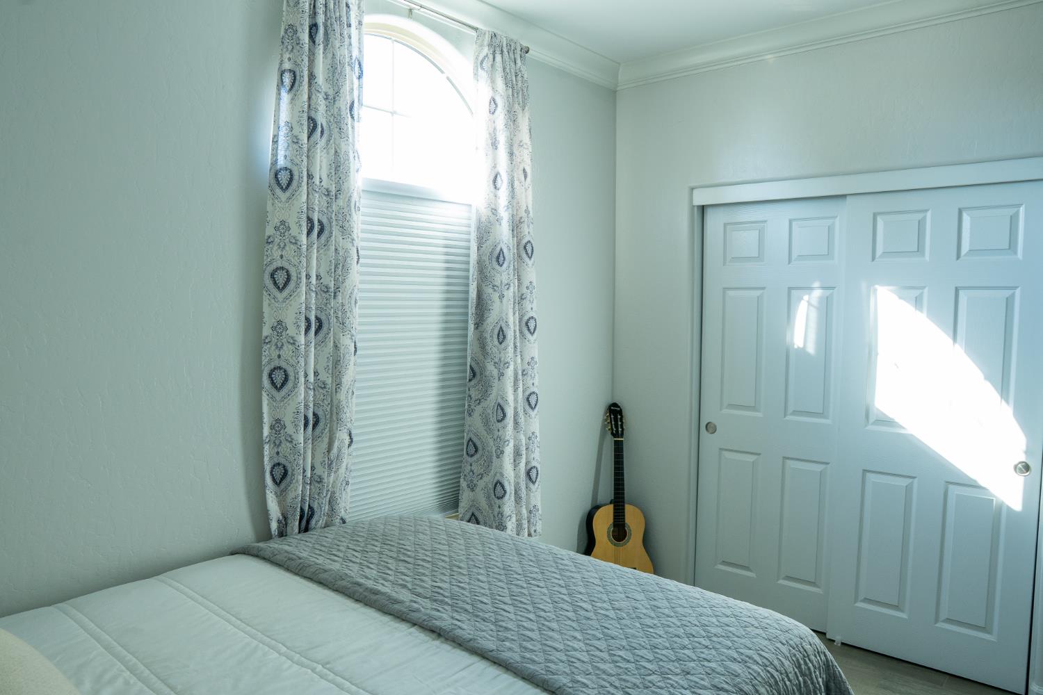 470 Daphne Lane Lemoore, CA 93245 - Photo 80 of 86 a bedroom with a bed and a chandelier