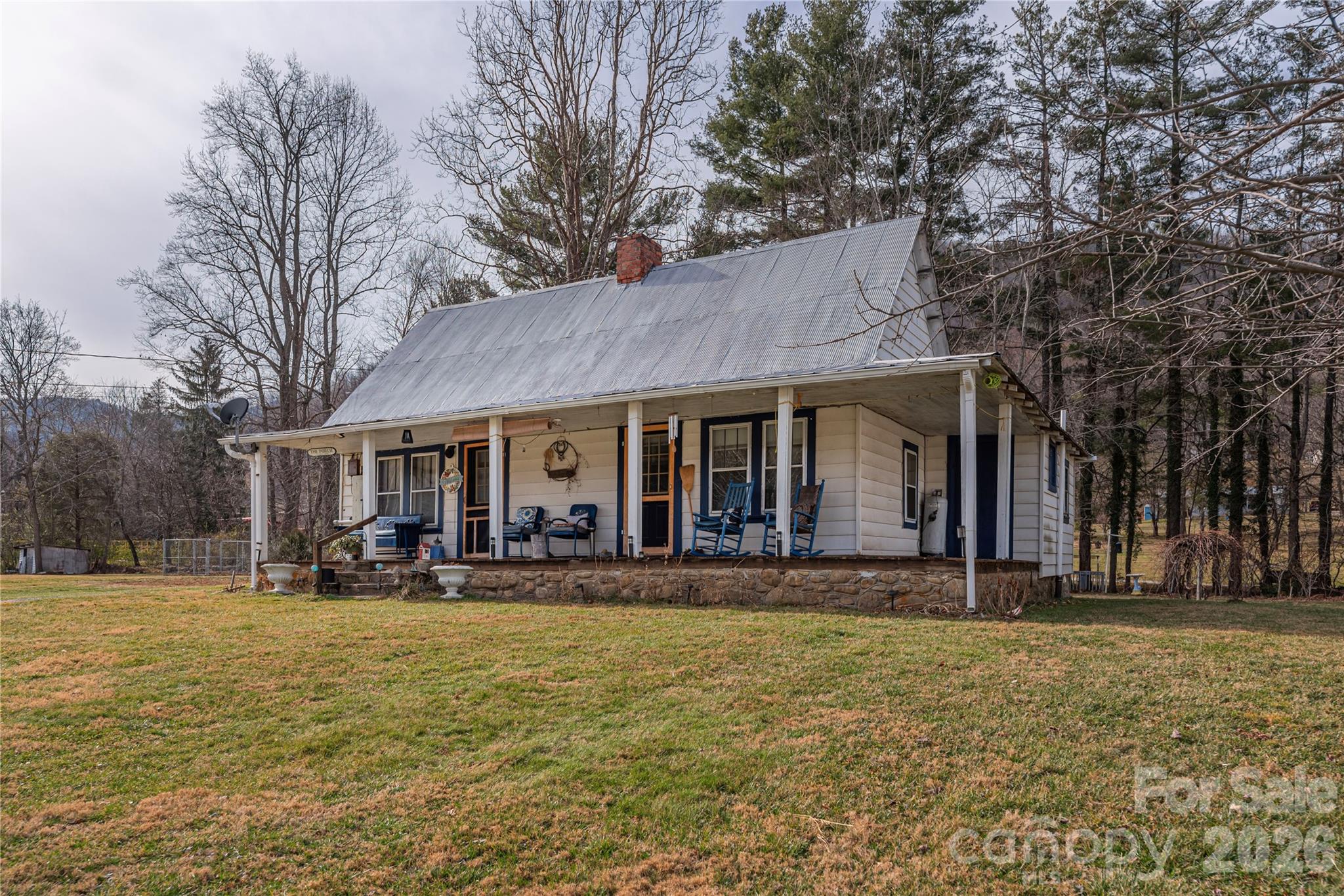 1496 Allens Creek Road Waynesville, NC 28786 - Photo 14 of 25 a front view of a building with a garden and trees