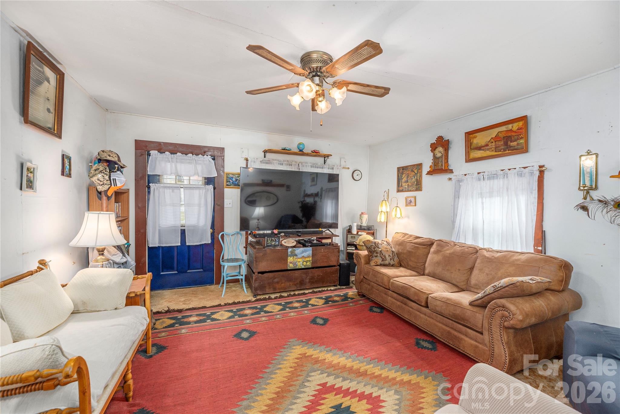 1496 Allens Creek Road Waynesville, NC 28786 - Photo 6 of 25 a living room with furniture and a flat screen tv