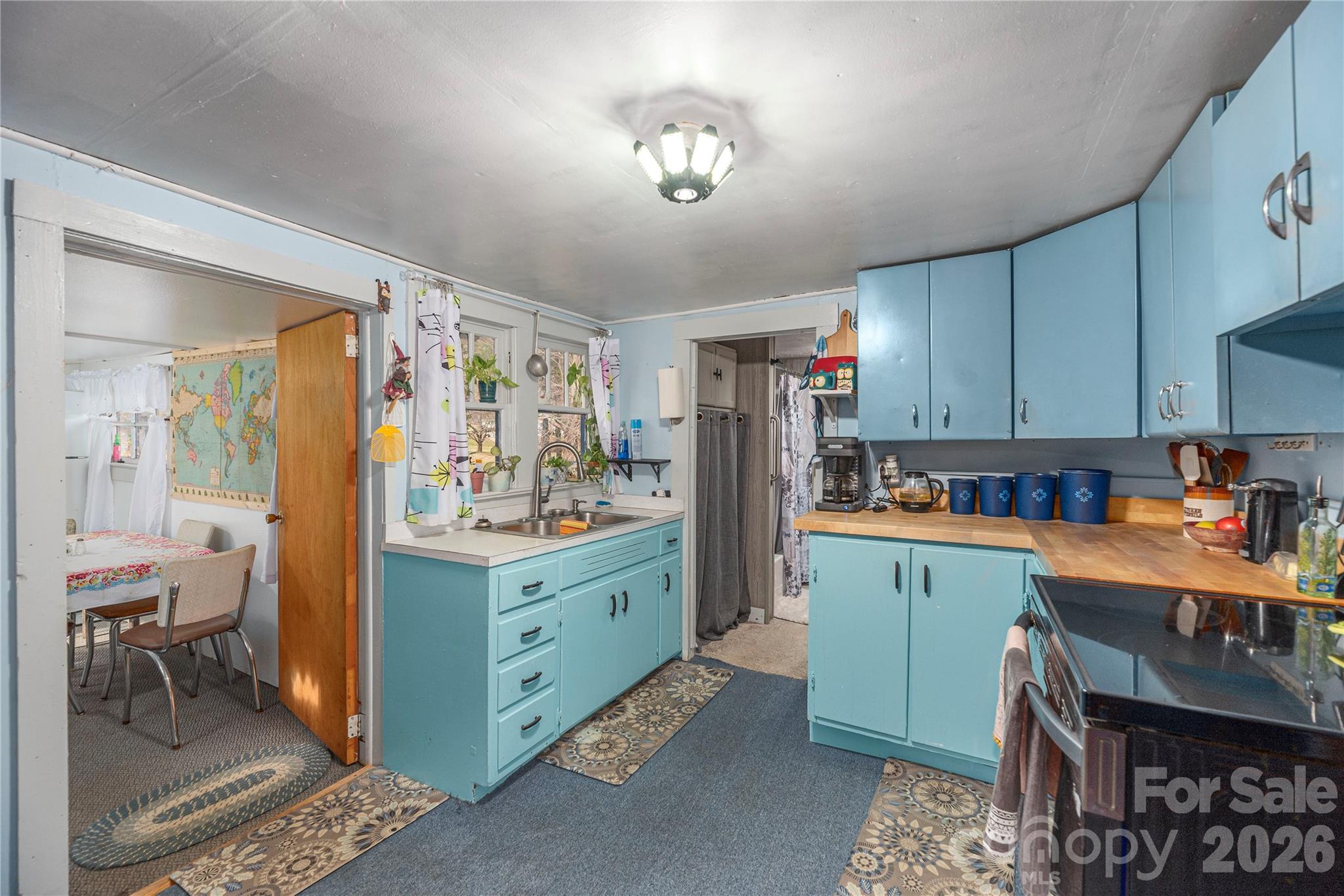 1496 Allens Creek Road Waynesville, NC 28786 - Photo 8 of 25 a kitchen that has a lot of cabinets a sink and appliances in it