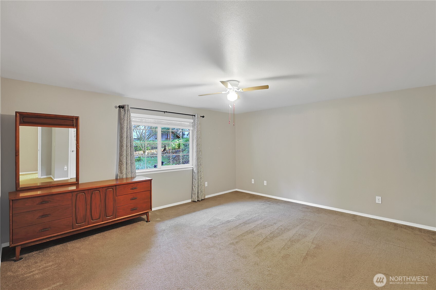17538 Loop Lane Southeast Yelm, WA 98597 - Photo 14 of 20 an empty room with windows and chandelier fan