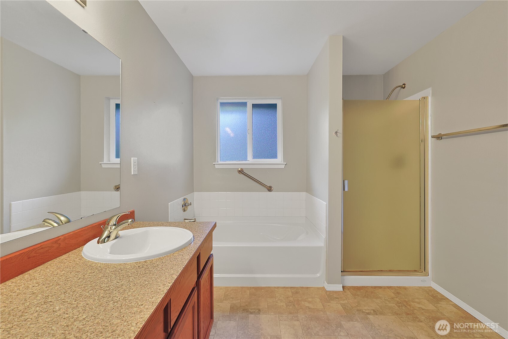 17538 Loop Lane Southeast Yelm, WA 98597 - Photo 16 of 20 a bathroom with a granite countertop sink and a mirror