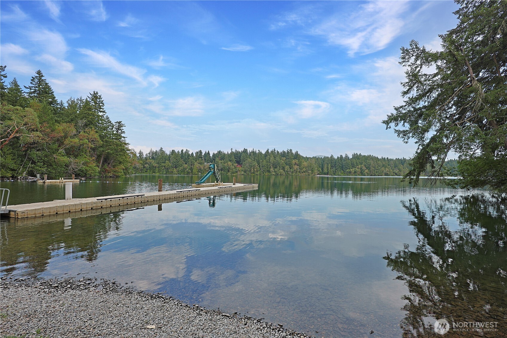 17538 Loop Lane Southeast Yelm, WA 98597 - Photo 2 of 20 a view of a lake with houses in the background
