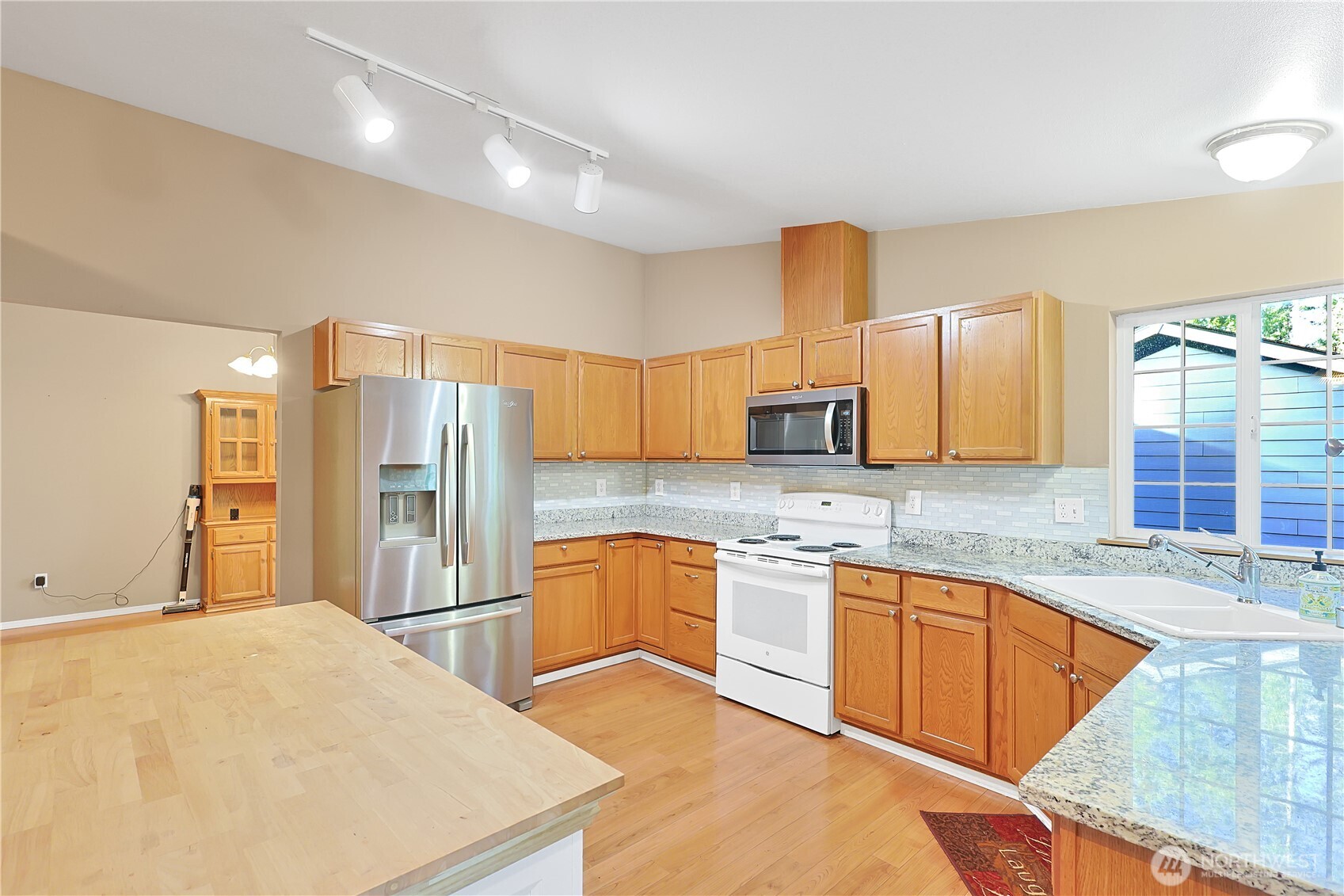 17538 Loop Lane Southeast Yelm, WA 98597 - Photo 9 of 20 a kitchen with stainless steel appliances granite countertop a sink refrigerator and cabinets