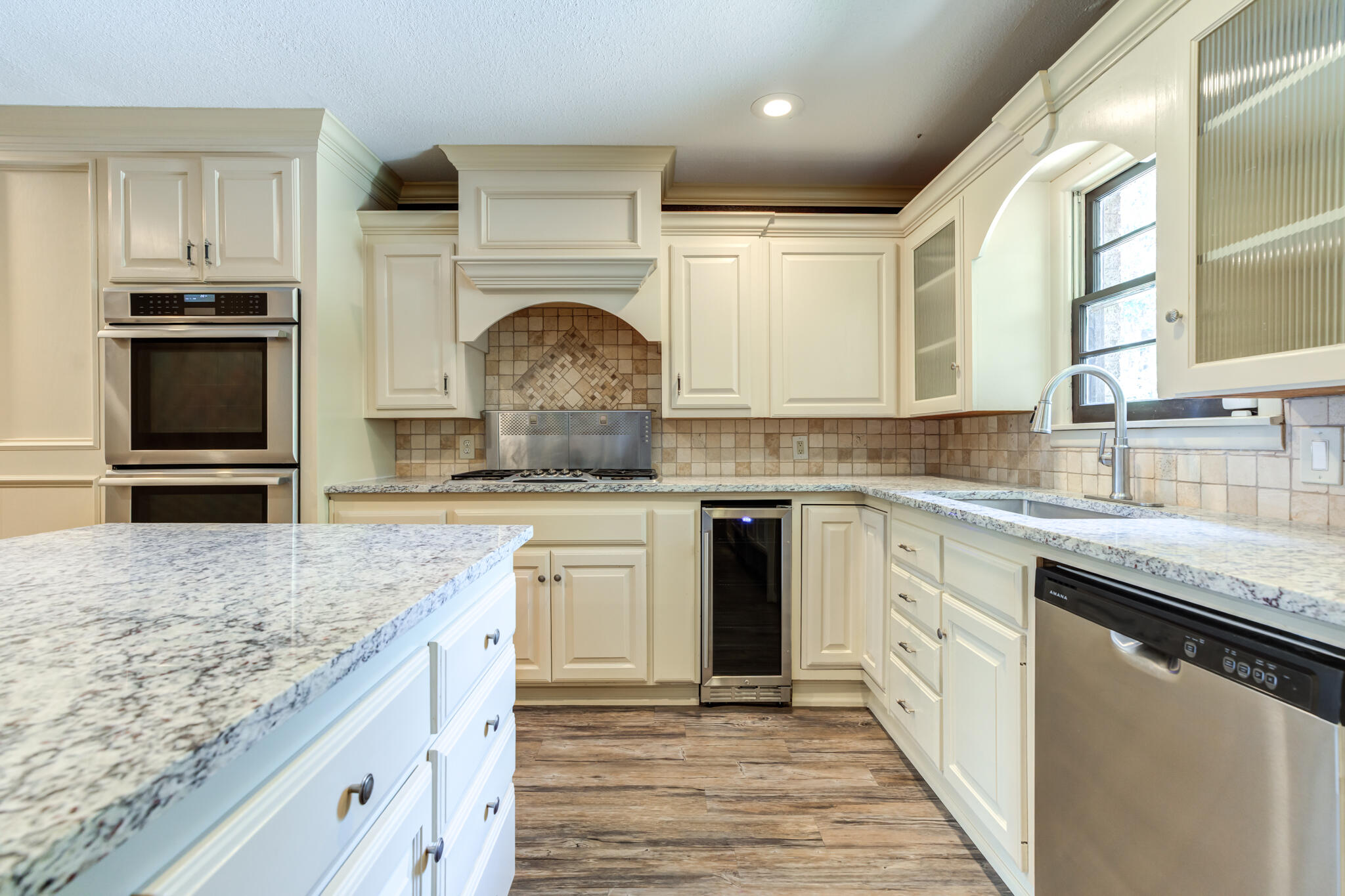 3511 44th Street Lubbock, TX 79413 - Photo 11 of 24 a kitchen with stainless steel appliances granite countertop a sink stove and refrigerator